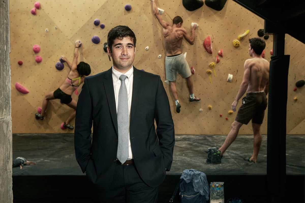 Man in climbing gym wearing suit